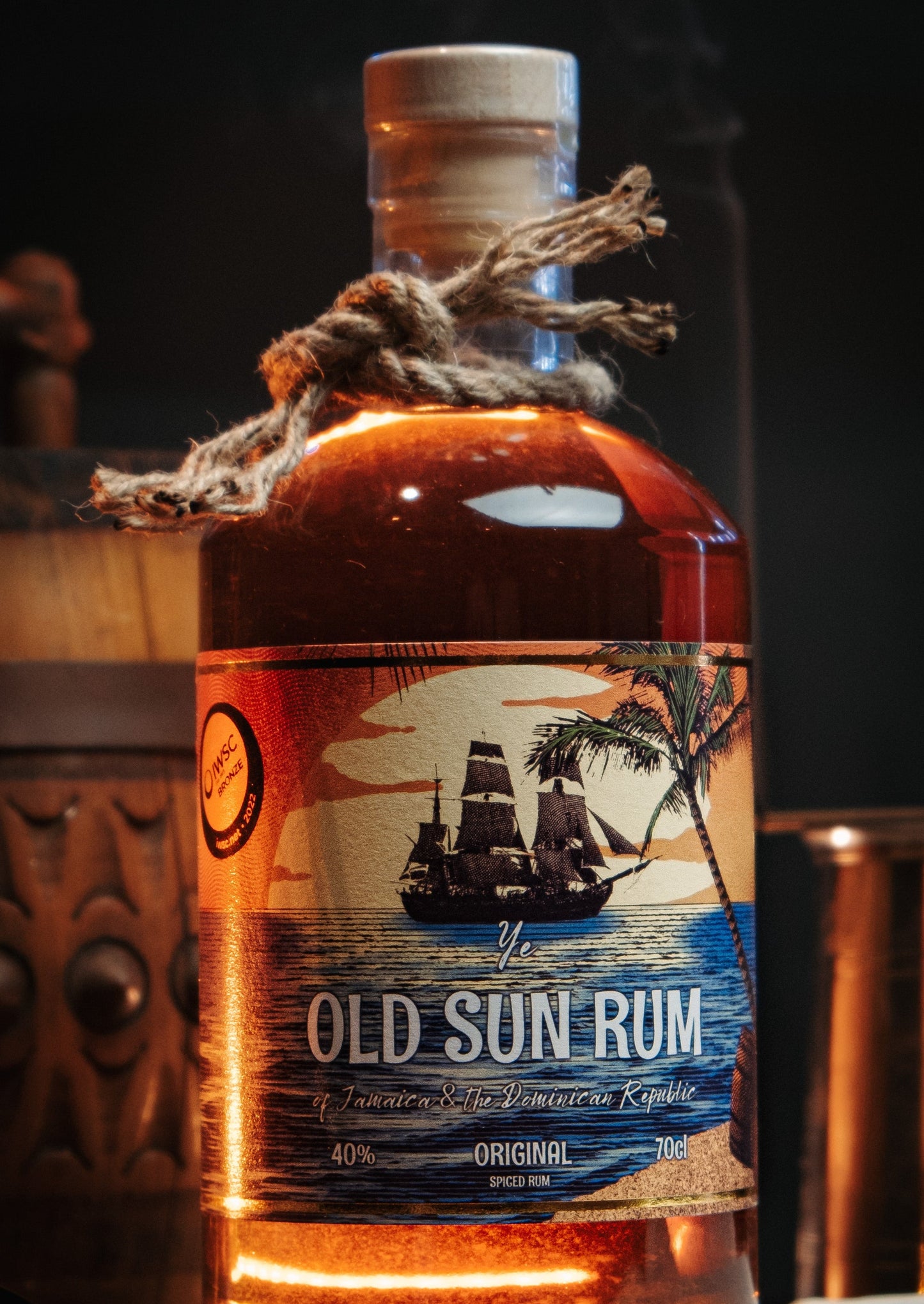 a bottle of old sun rum origianl spiced sitting on a desk in a pirates captains office